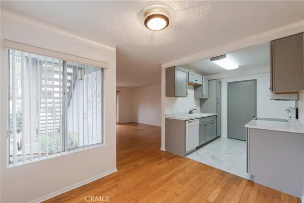 a kitchen with a stove cabinets and a wooden floor