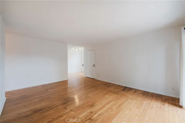 a view of an empty room and wooden floor
