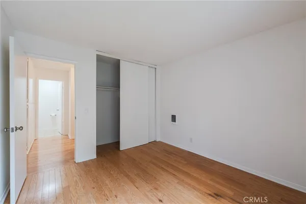 a view of a room with wooden floor and a bathroom