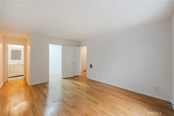 a view of an empty room and wooden floor