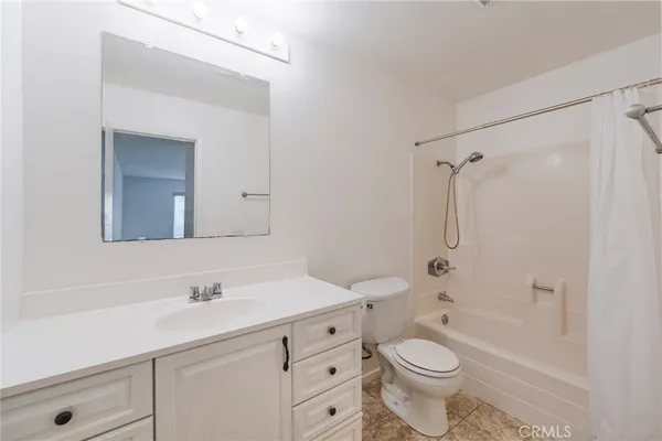 a bathroom with a double vanity sink toilet mirror and shower