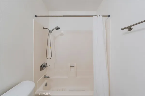 a bathroom with a shower and a toilet