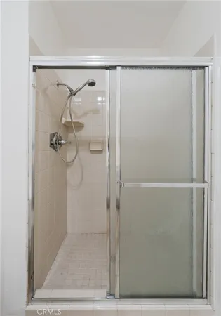 a bathroom with a glass shower door
