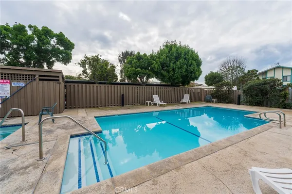 a view of swimming pool with chairs