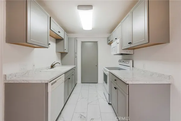 a large kitchen with a sink and cabinets
