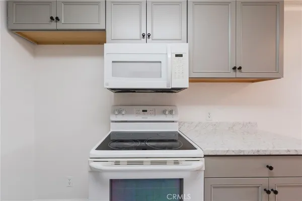 a stove top oven sitting inside of a kitchen