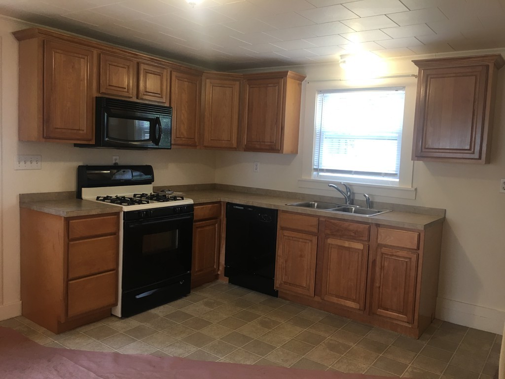 135 Old Coldbrook Road Barre, MA 01005 - Photo 4 of 7 a kitchen with granite countertop a stove a sink and a microwave