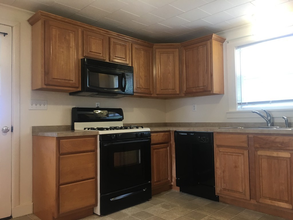 135 Old Coldbrook Road Barre, MA 01005 - Photo 6 of 7 a kitchen with granite countertop wooden cabinets and a stove top oven