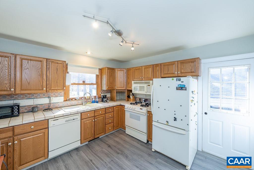 75 Amethyst Road Palmyra, VA 22963 - Photo 25 of 42 a kitchen with white cabinets and white appliances