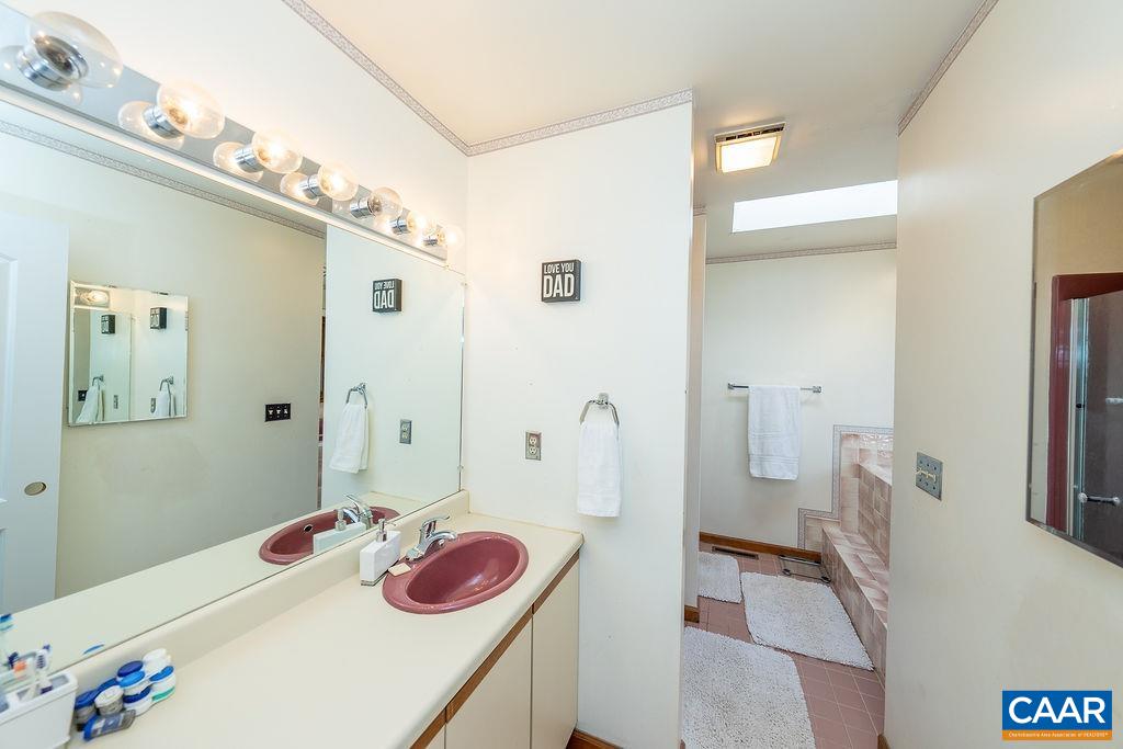 75 Amethyst Road Palmyra, VA 22963 - Photo 31 of 42 a bathroom with a tub sink and a mirror