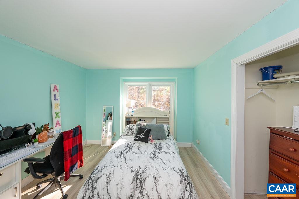 75 Amethyst Road Palmyra, VA 22963 - Photo 34 of 42 a bedroom with a bed and a wooden floor