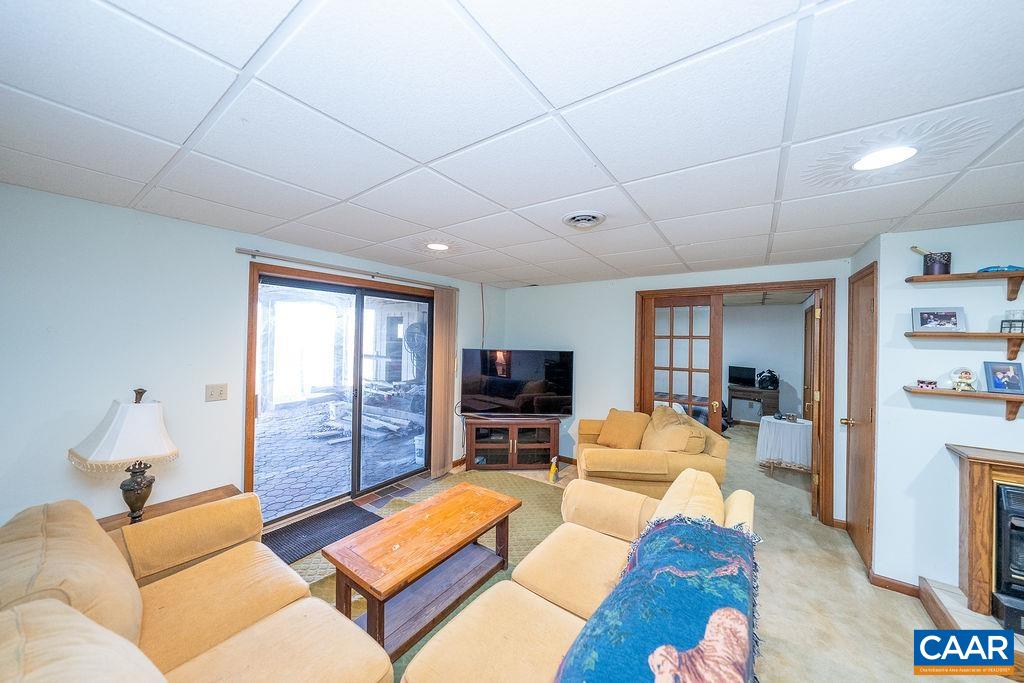 75 Amethyst Road Palmyra, VA 22963 - Photo 39 of 42 a living room with furniture flat screen tv and a fireplace