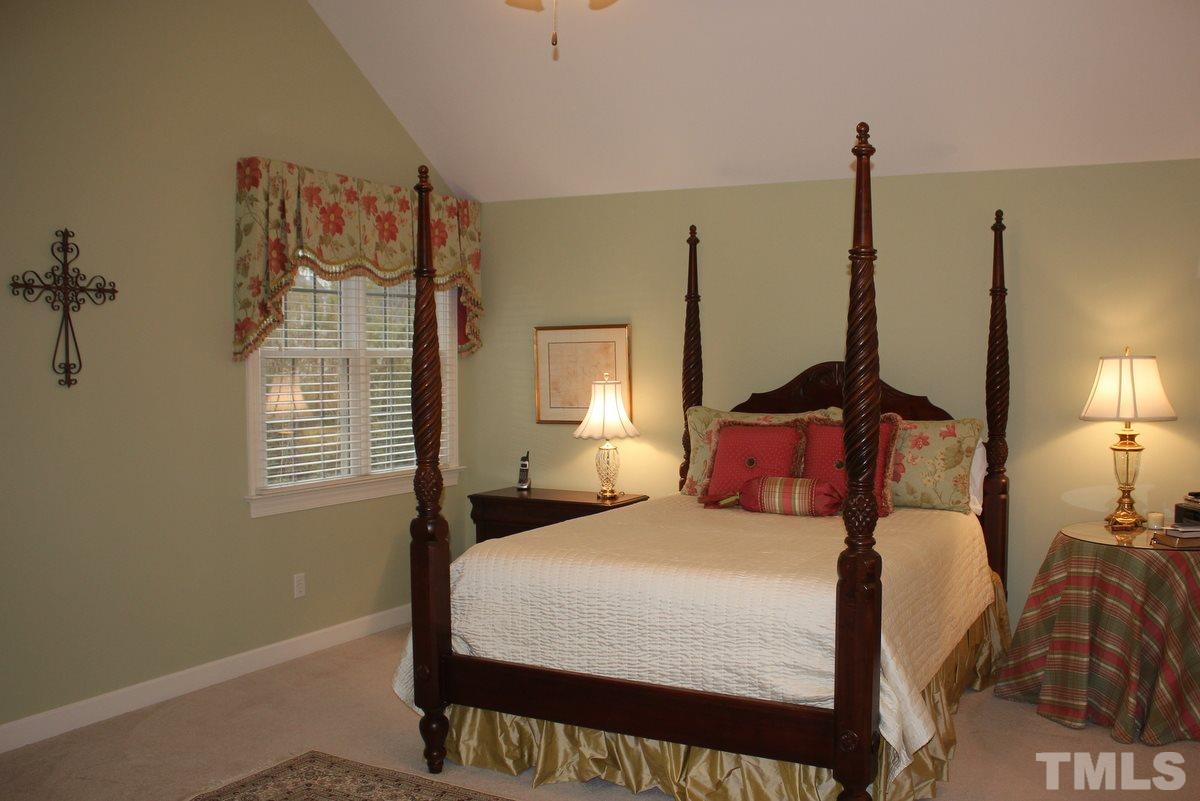 7405 Fontana Ridge Lane Raleigh, NC 27613 - Photo 17 of 25 a bedroom with a bed and wooden floor
