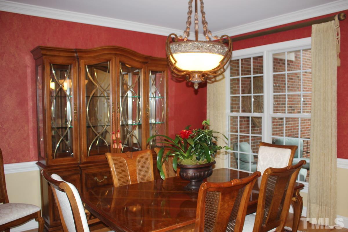7405 Fontana Ridge Lane Raleigh, NC 27613 - Photo 3 of 25 a view of a dining room with furniture and chandelier