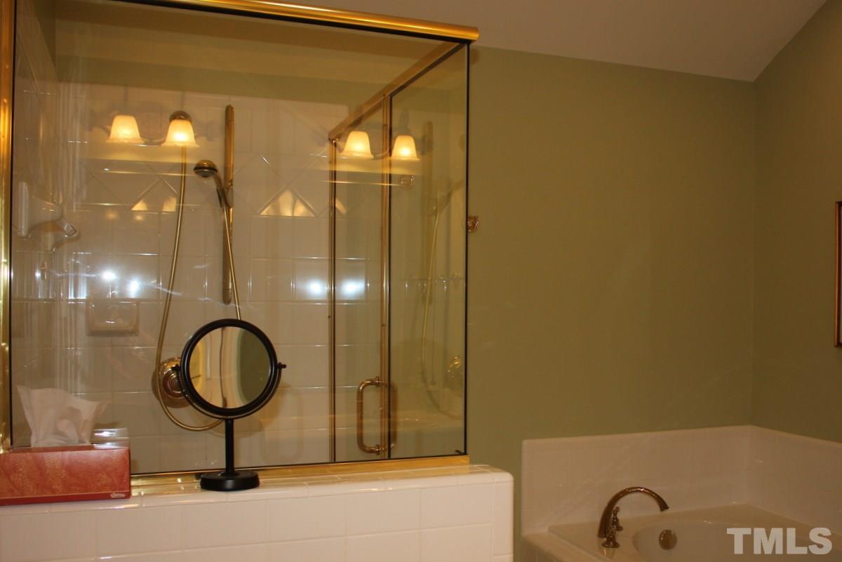 7405 Fontana Ridge Lane Raleigh, NC 27613 - Photo 21 of 25 a bathroom with a sink a light fixture and a mirror