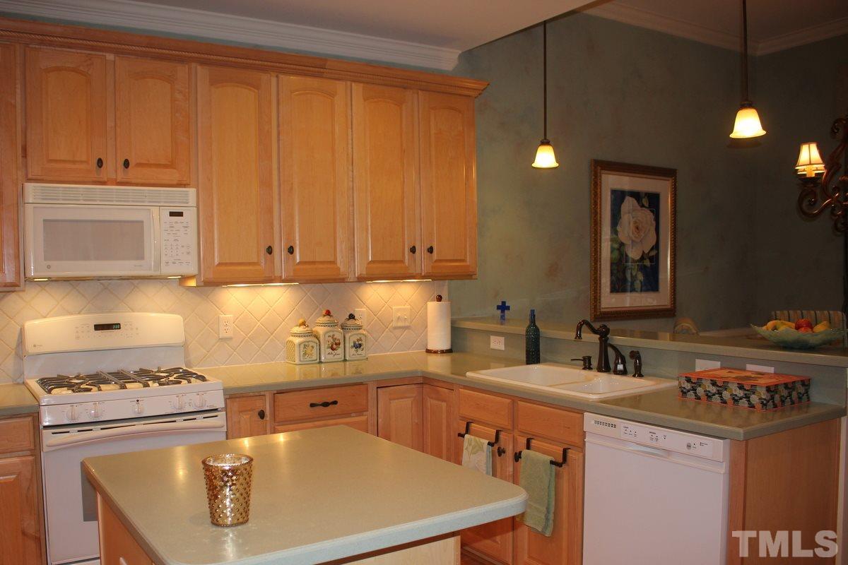 7405 Fontana Ridge Lane Raleigh, NC 27613 - Photo 6 of 25 a kitchen with a sink a stove and cabinets