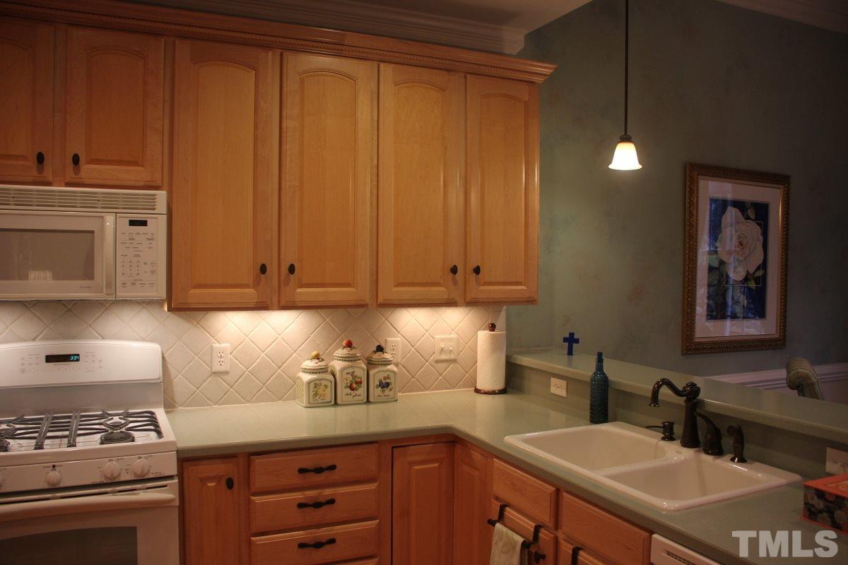 7405 Fontana Ridge Lane Raleigh, NC 27613 - Photo 8 of 25 a kitchen with a sink cabinets and appliances