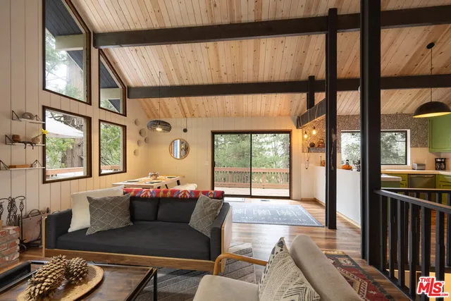 a living room with furniture fireplace and flat screen tv