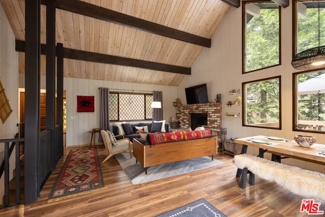 a dining room with furniture and a large window