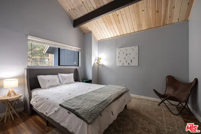 a bathroom with a granite countertop toilet a sink and mirror