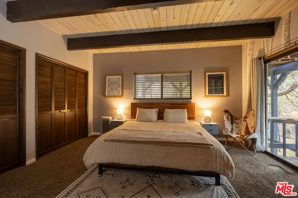 a bedroom with a large bed and a large window
