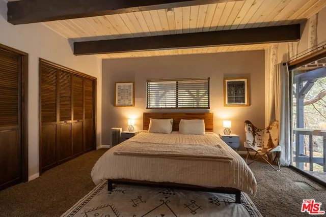 a bedroom with a large bed and a large window