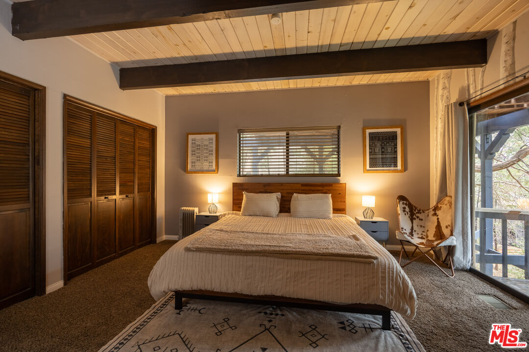 26645 Lake Forest Drive Twin Peaks, CA 92391 - Photo 19 of 30 a bed sitting in a bedroom next to a window