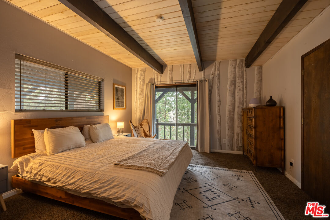26645 Lake Forest Drive Twin Peaks, CA 92391 - Photo 20 of 30 a bedroom with a large bed and a large window