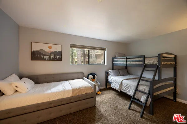 a bedroom with bed and a window