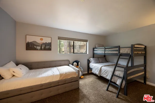 a bedroom with bed and a window