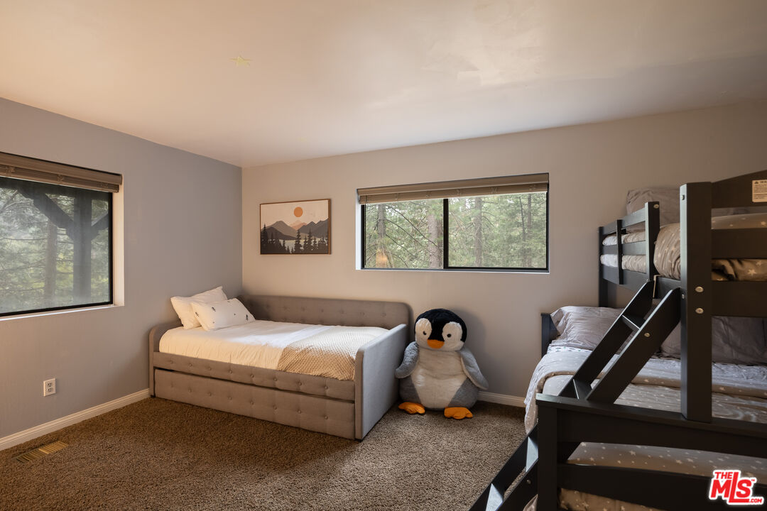 26645 Lake Forest Drive Twin Peaks, CA 92391 - Photo 22 of 30 a bedroom with bed and a window