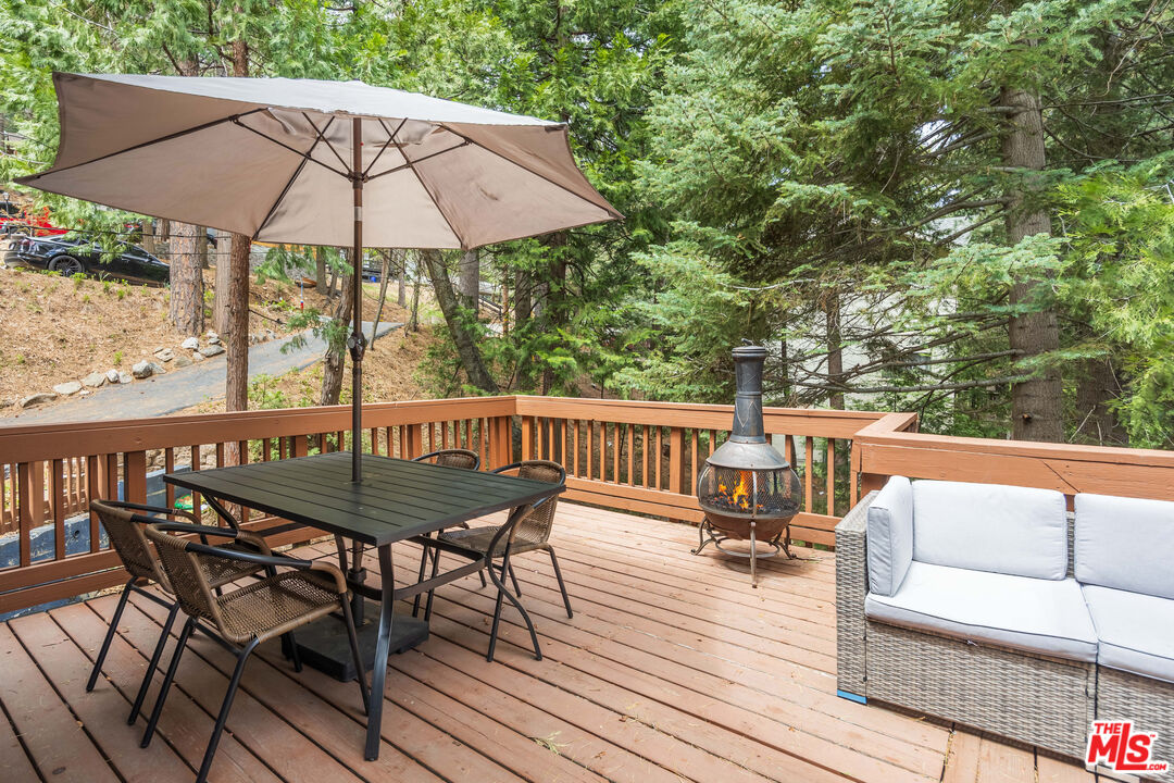 26645 Lake Forest Drive Twin Peaks, CA 92391 - Photo 23 of 30 a view of balcony with outdoor seating and wooden floor