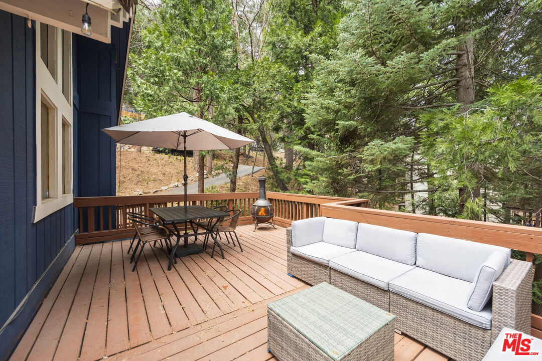 26645 Lake Forest Drive Twin Peaks, CA 92391 - Photo 24 of 30 an outdoor sitting area with furniture and wooden floor