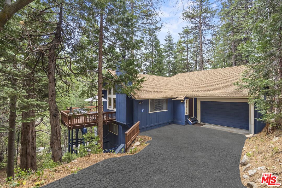 26645 Lake Forest Drive Twin Peaks, CA 92391 - Photo 5 of 30 a backyard of a house with table and chairs