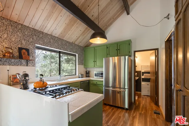 a kitchen with a refrigerator and a sink