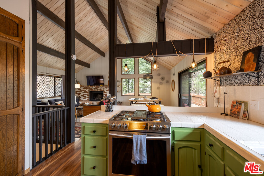 26645 Lake Forest Drive Twin Peaks, CA 92391 - Photo 9 of 30 a kitchen that has a sink and a stove