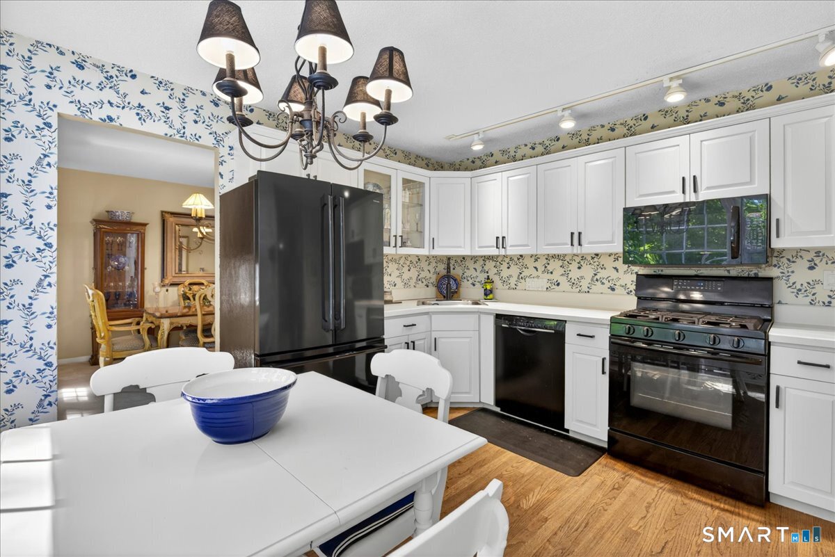 11 Bender Road Hamden, CT 06518 - Photo 12 of 40 a kitchen with stainless steel appliances a stove a sink and a refrigerator