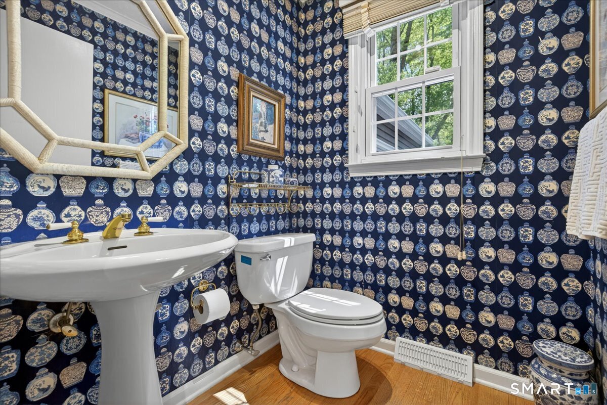 11 Bender Road Hamden, CT 06518 - Photo 19 of 40 a bathroom with a sink a toilet and a shower curtain