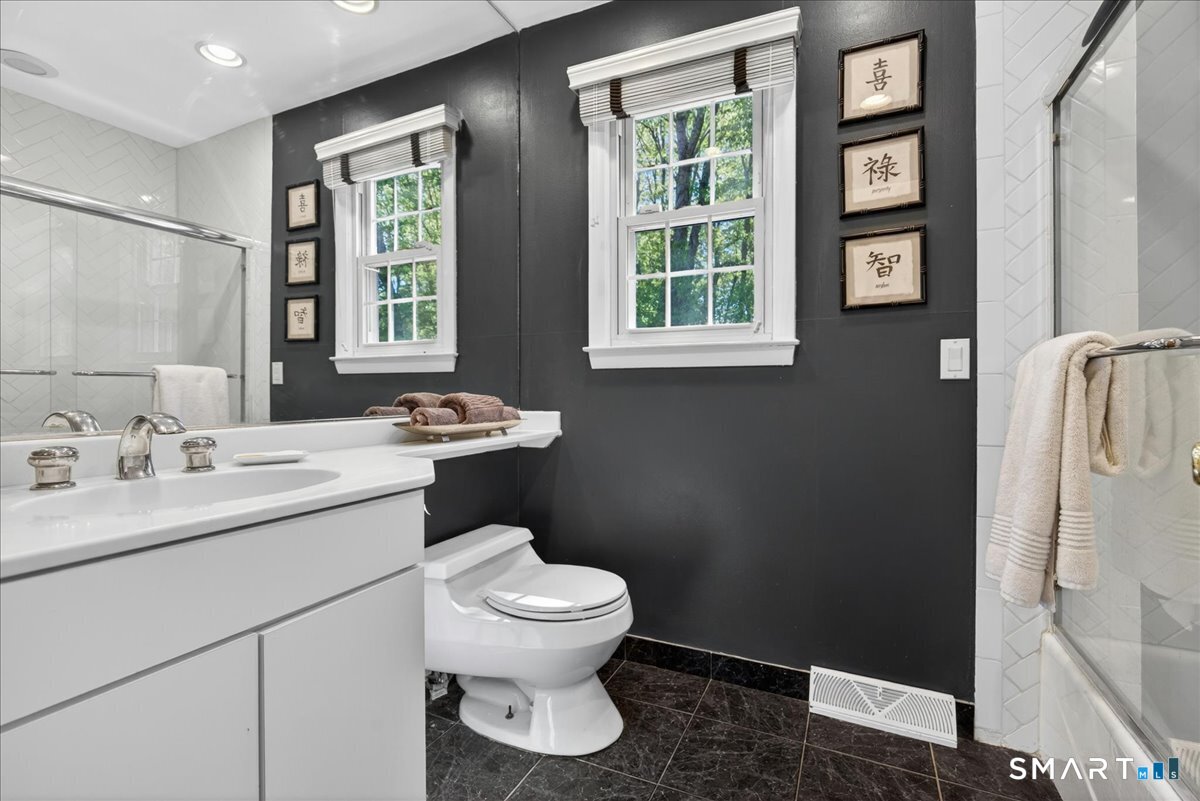 11 Bender Road Hamden, CT 06518 - Photo 27 of 40 a bathroom with a toilet sink and mirror