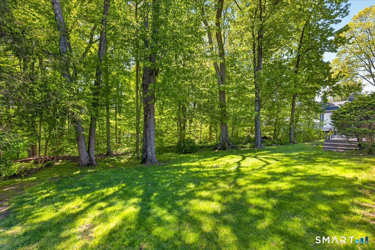 11 Bender Road Hamden, CT 06518 - Photo 32 of 40 a backyard of a house with lots of green space and fountain