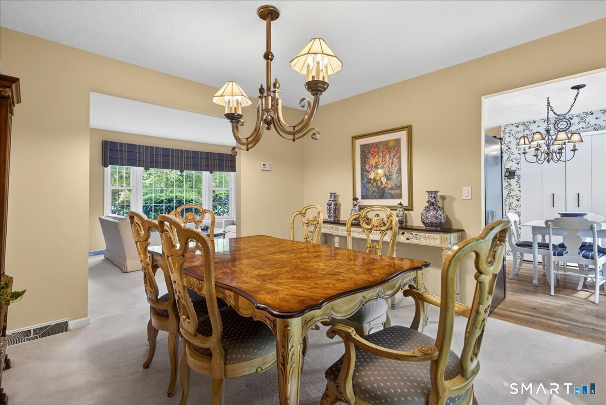 11 Bender Road Hamden, CT 06518 - Photo 7 of 40 a view of a dining room with furniture wooden floor and chandelier