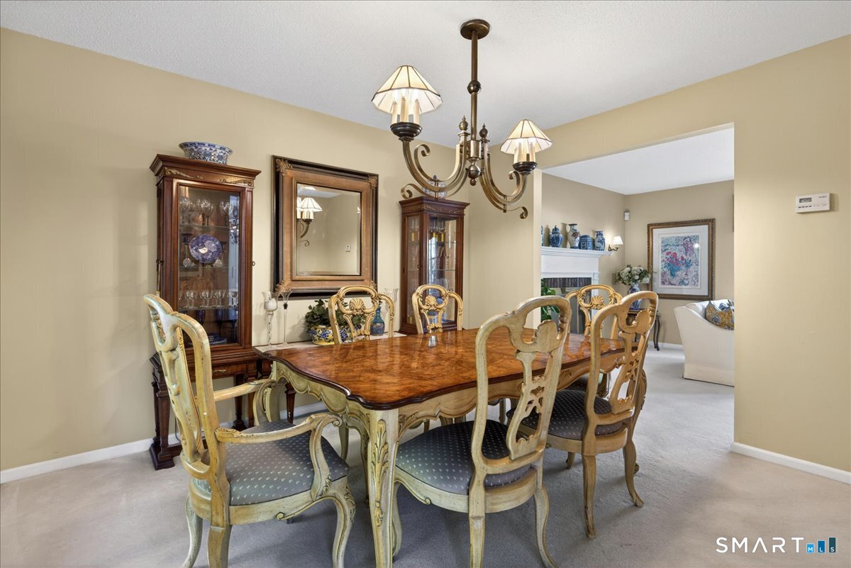 11 Bender Road Hamden, CT 06518 - Photo 8 of 40 a view of a dining room with furniture wooden floor and chandelier