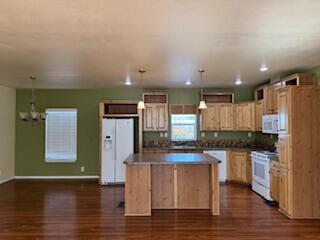 355 Colver Road, Unit 24 Talent, OR 97540 - Photo 7 of 21 a kitchen with stainless steel appliances granite countertop a refrigerator a stove and a wooden floors
