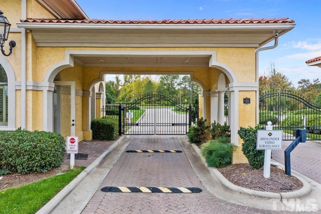 47 Treviso Place Durham, NC 27707 - Photo 25 of 38 a view of a house with a small yard plants and a large tree