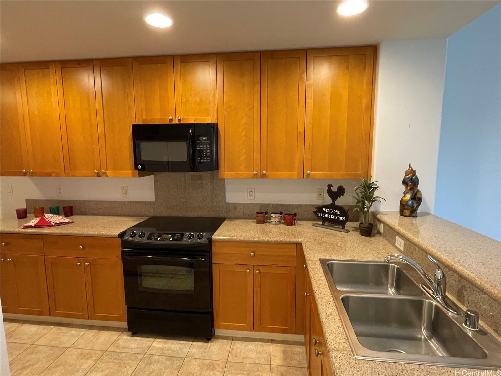 a kitchen with a sink and a stove top oven