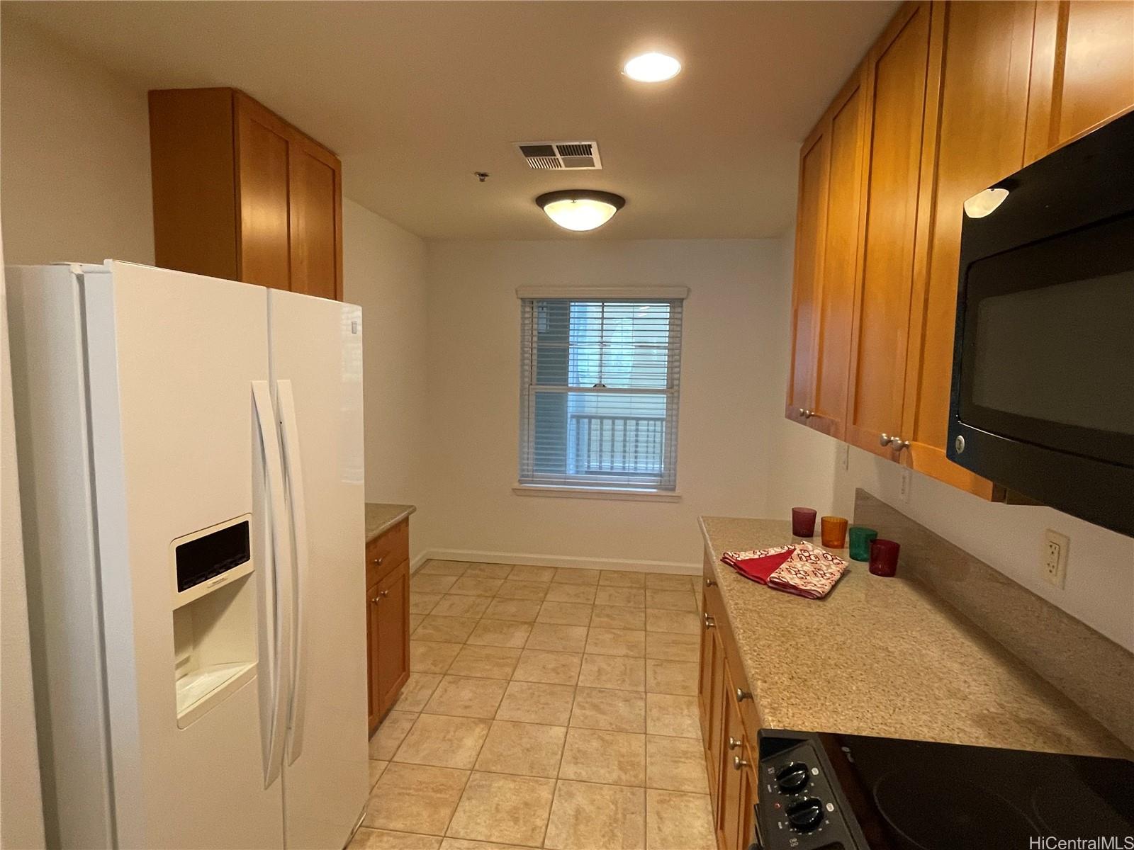 520 Lunalilo Home Road, Unit 8225 Honolulu, HI 96825 - Photo 3 of 25 a kitchen with granite countertop a refrigerator and a sink
