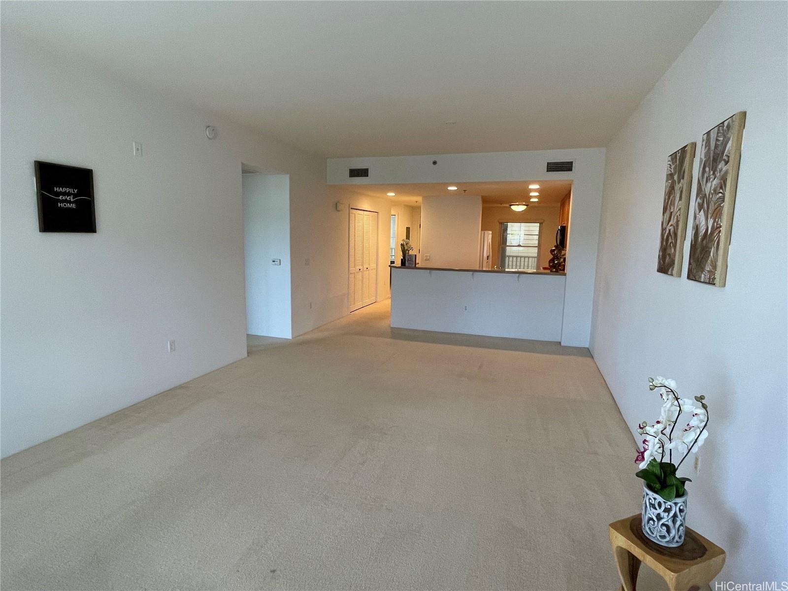 520 Lunalilo Home Road, Unit 8225 Honolulu, HI 96825 - Photo 7 of 25 a view of a hallway with wooden floor and a potted plant