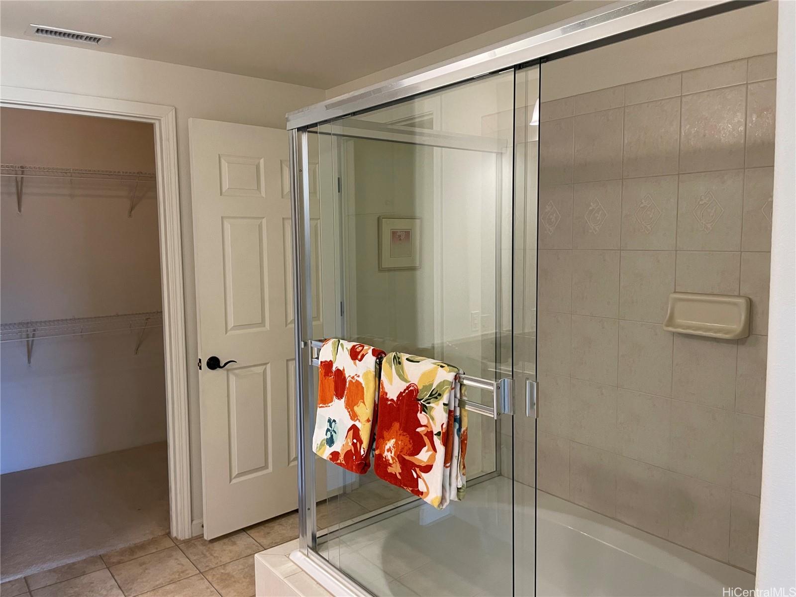 520 Lunalilo Home Road, Unit 8225 Honolulu, HI 96825 - Photo 10 of 25 a bathroom with a glass shower door