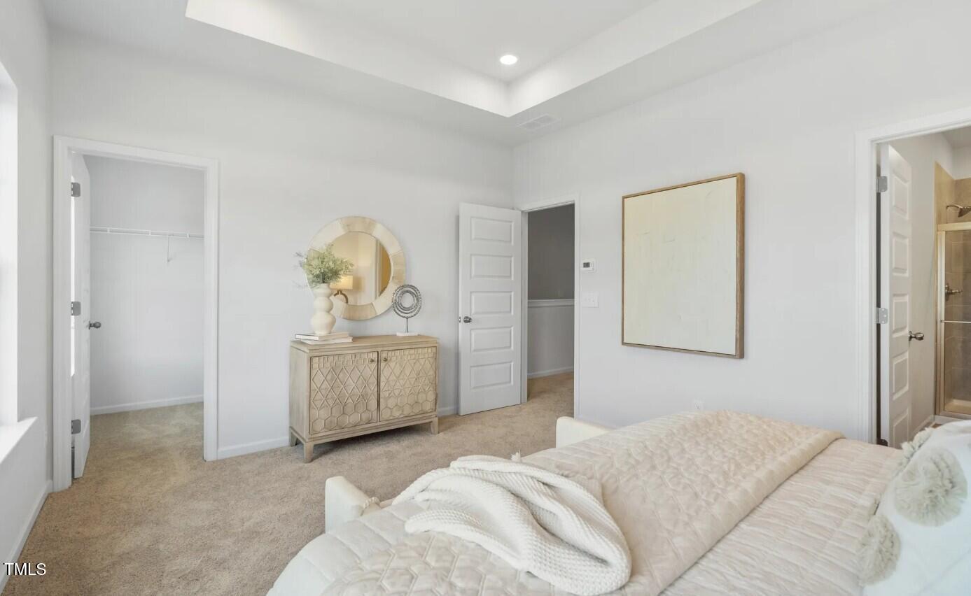 732 Orch Vista Circle Raleigh, NC 27606 - Photo 12 of 19 a bedroom with a bed and painting on the wall