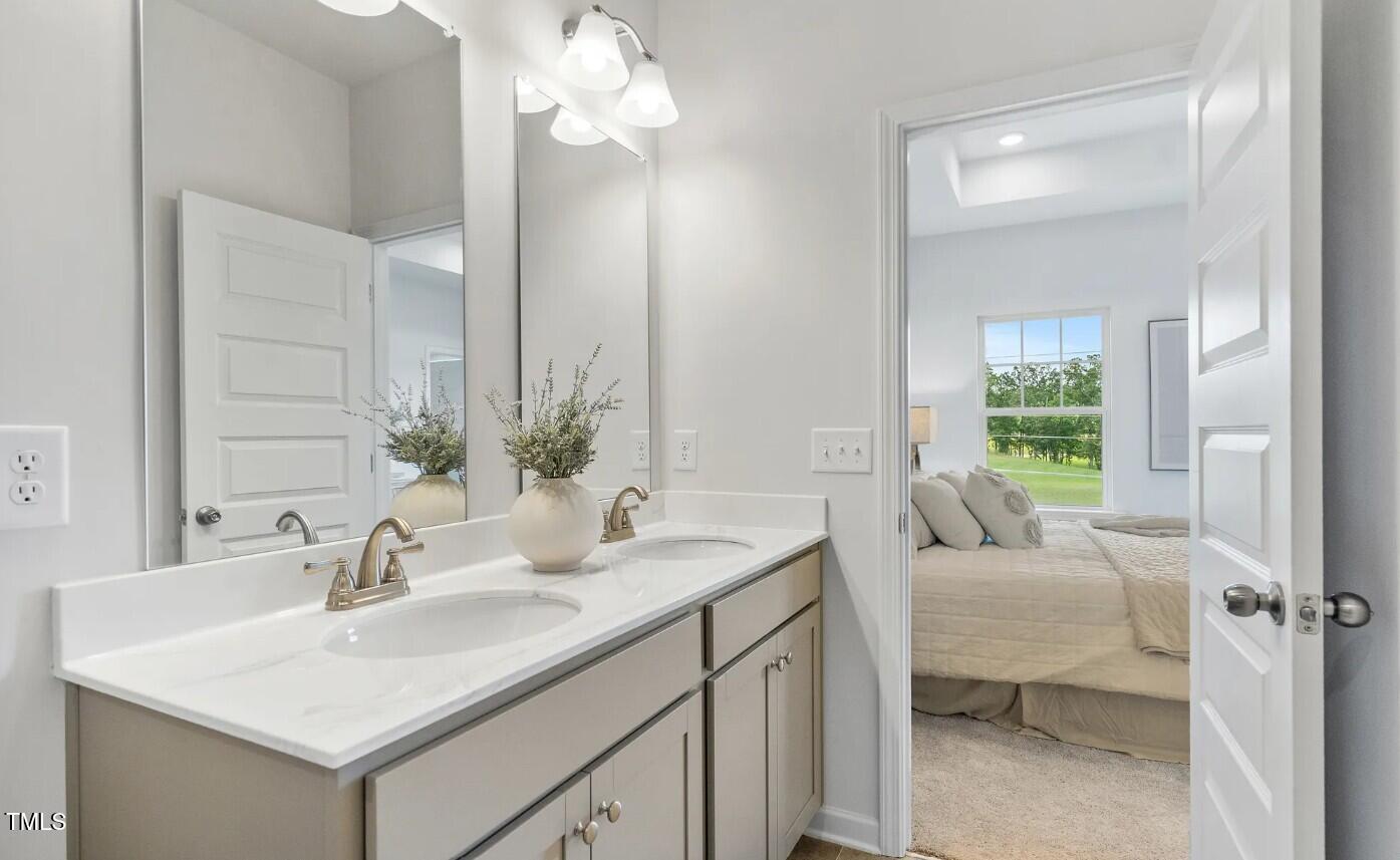 732 Orch Vista Circle Raleigh, NC 27606 - Photo 14 of 19 a en suite bathroom with a sink and a mirror